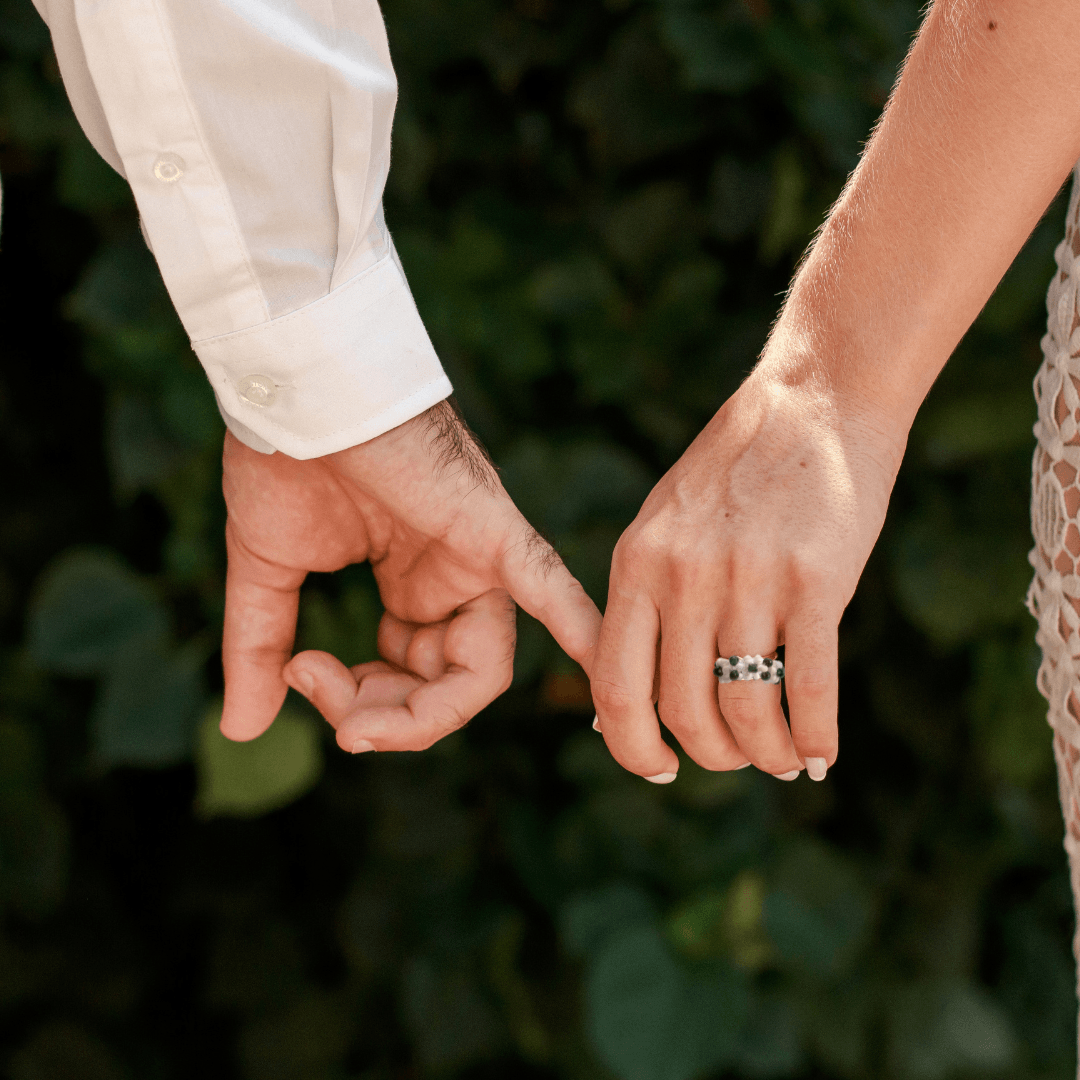 Woman wearing shungite and flower ring bundle, bringing style and protection to a formal outfit