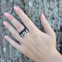 Shungite and flower ring bundle, bringing style and protection to a woman's hand