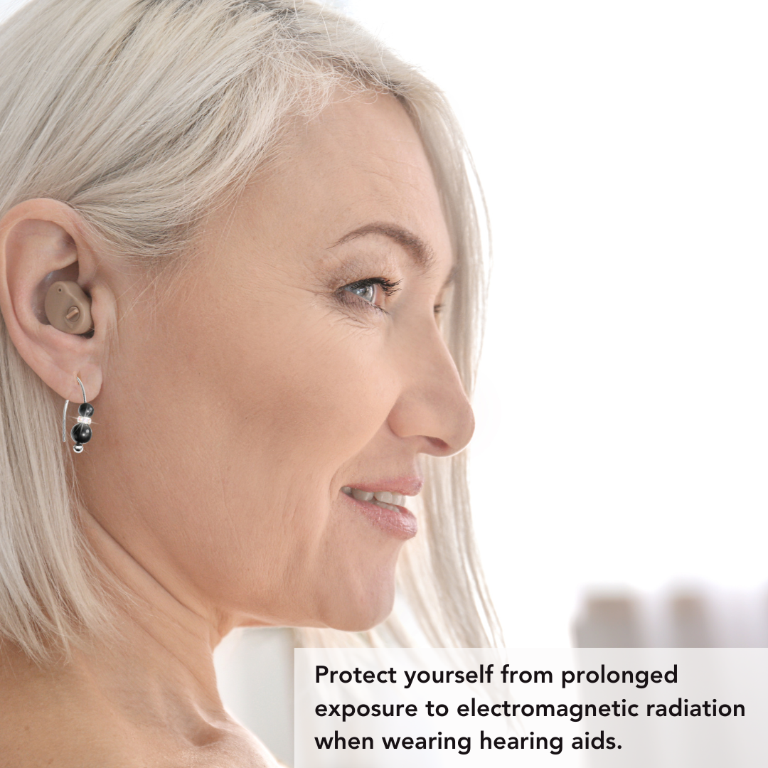 Woman wearing shungite earrings to protect her from harmful EMF radiation near her head, produced by her hearing aids