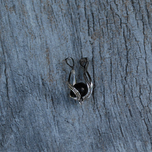 Sterling silver cage with a 6mm shungite stone open and ready to change out the stone inside, with 9 different options