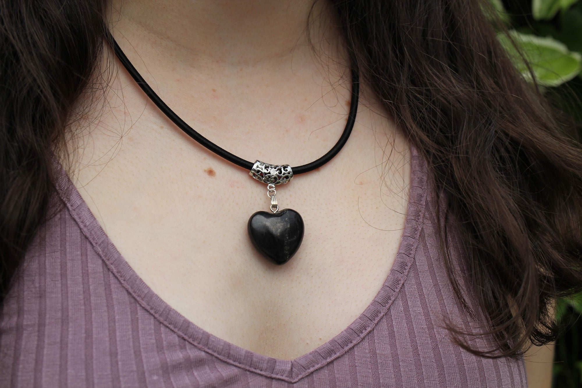 Young woman brings style, love, and protection to her outfit while wearing the puffy heart pendant on a leather cord