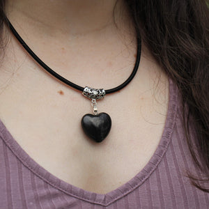 Young woman brings style, love, and protection to her outfit while wearing the puffy heart pendant on a leather cord