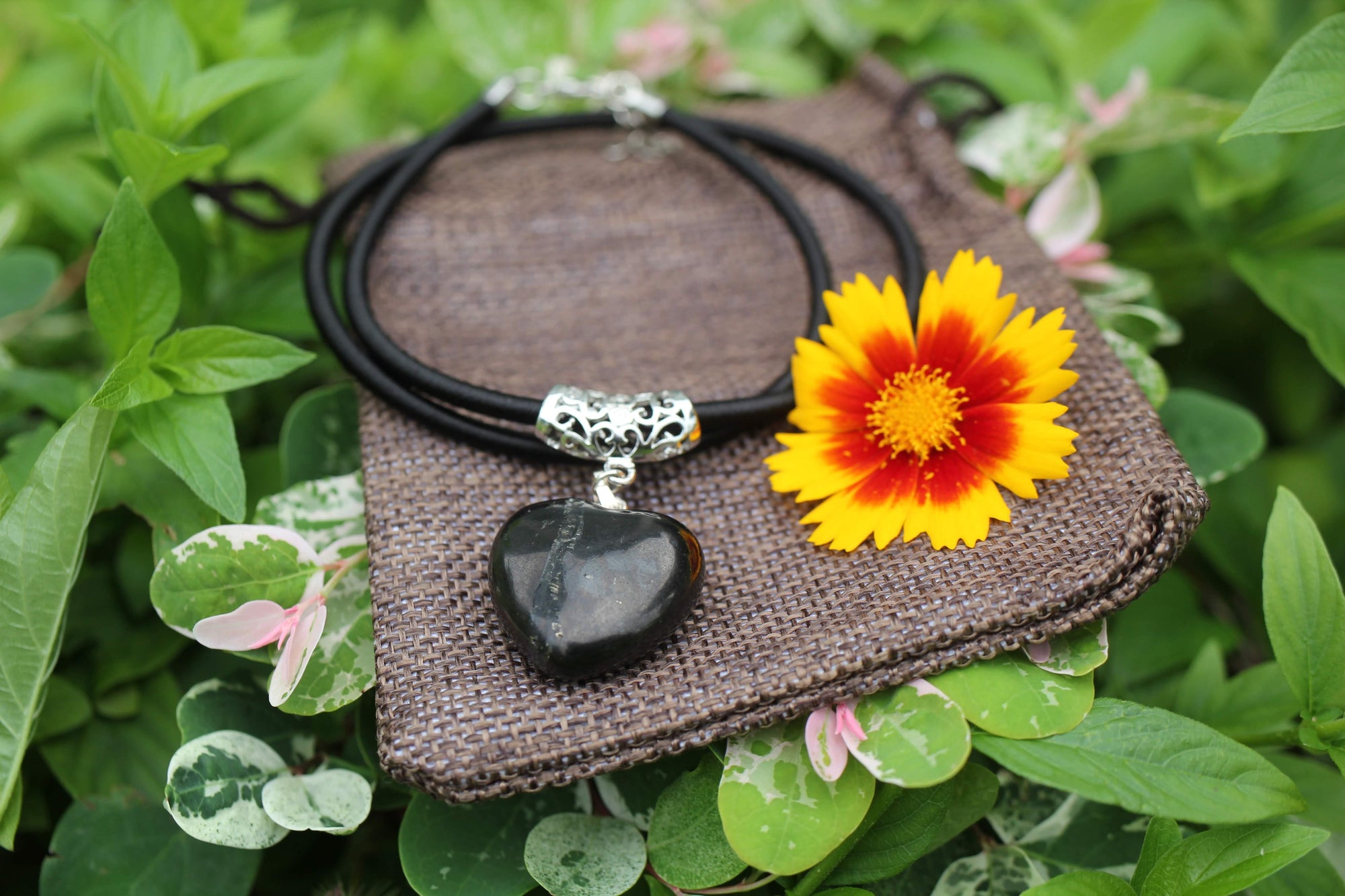 Puffy Heart Polished Shungite Pendant on a braided leather cord and silver-plated bail