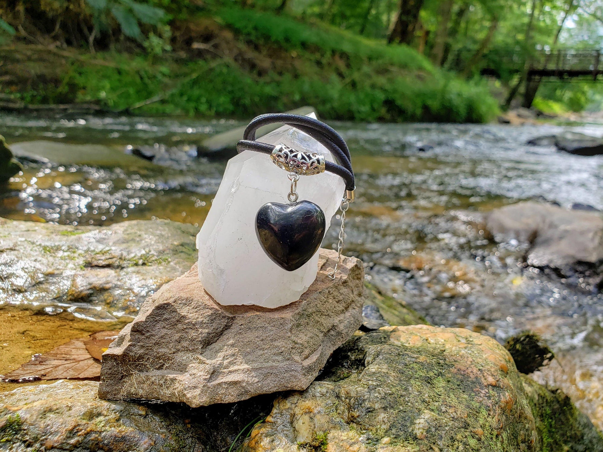 Puffy Heart Polished Shungite Pendant on a braided leather cord and silver-plated bail