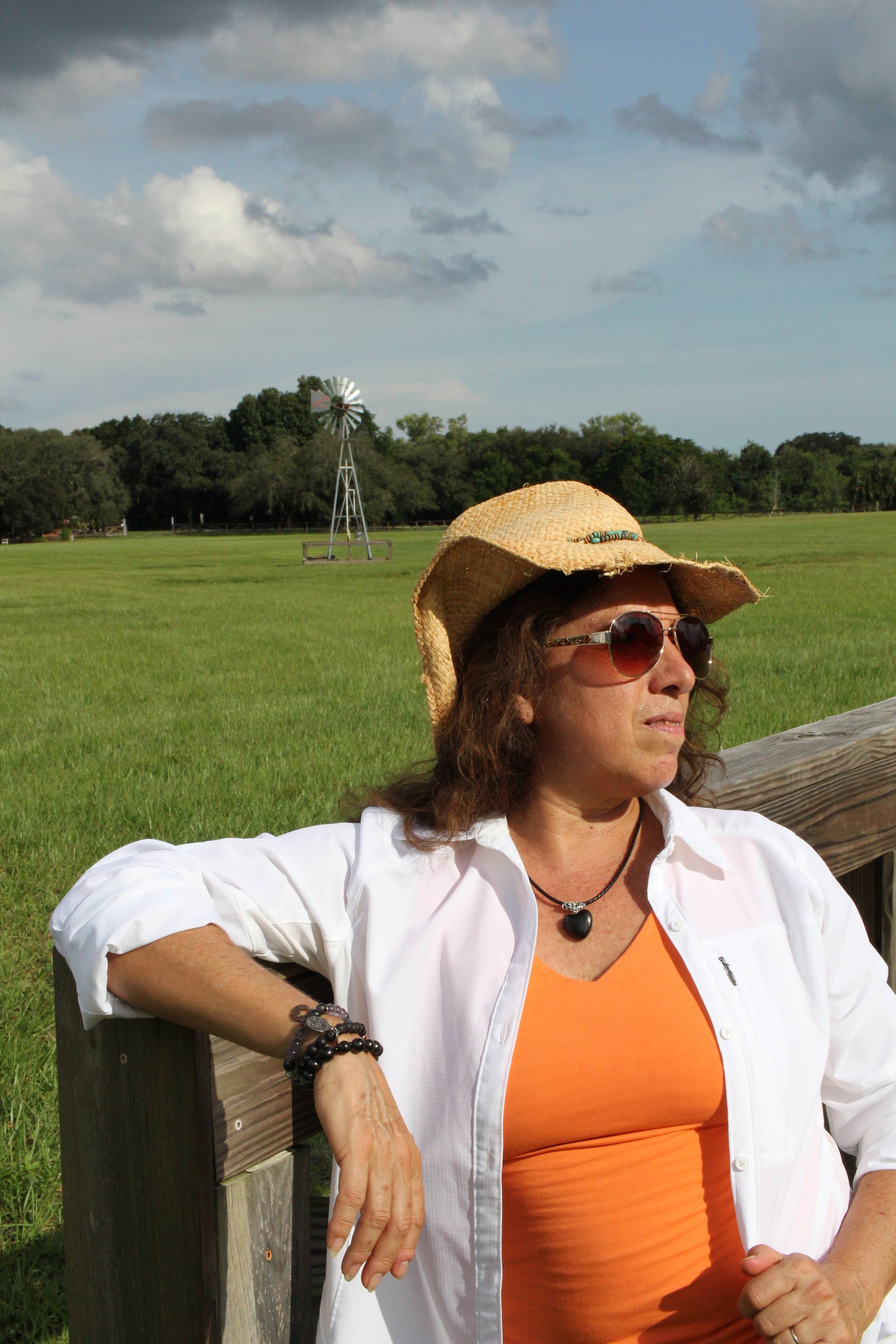 Woman brings style, love, and protection to her outfit while wearing the puffy heart pendant on a leather cord