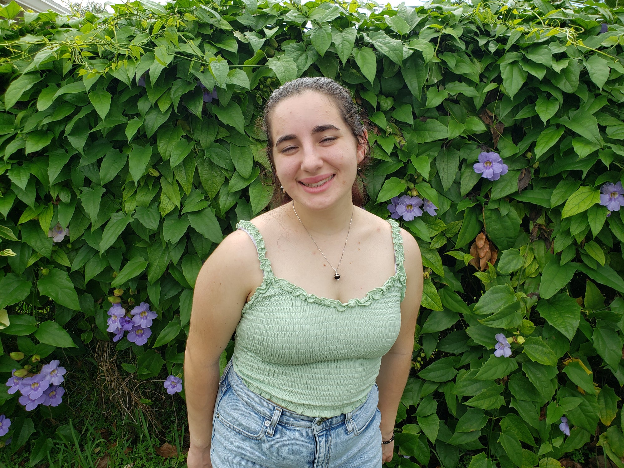 Young woman wearing the Shungite Orbit Pendant on a sterling silver chain