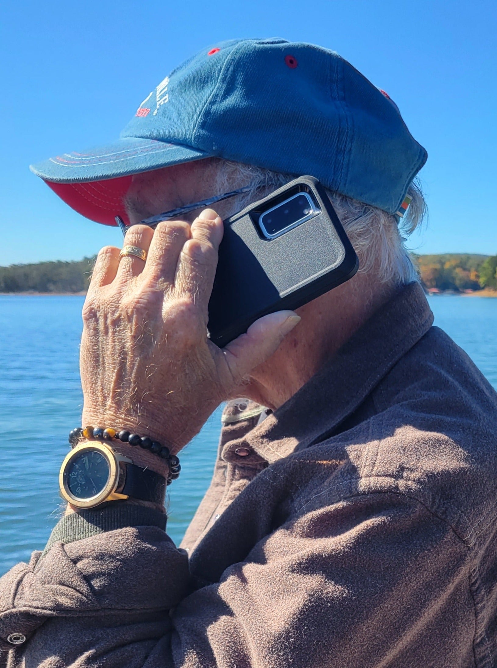 8mm shungite, tiger's eye, and hematite Triple Protection bracelet on an older man